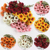 A collection of artificial silk gerbera daisy flowers in shades of orange, pink, and deep red.