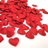 A pile of red fabric heart throwing petals for weddings and parties.
