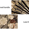 Close-up of a vintage Chinese rose lace folding fan with a thickened handle.