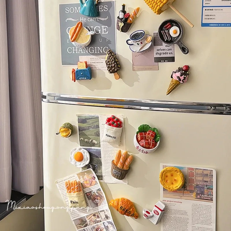 Gros plan sur une porte de réfrigérateur décorée de divers aimants et étiquettes à thème alimentaire.