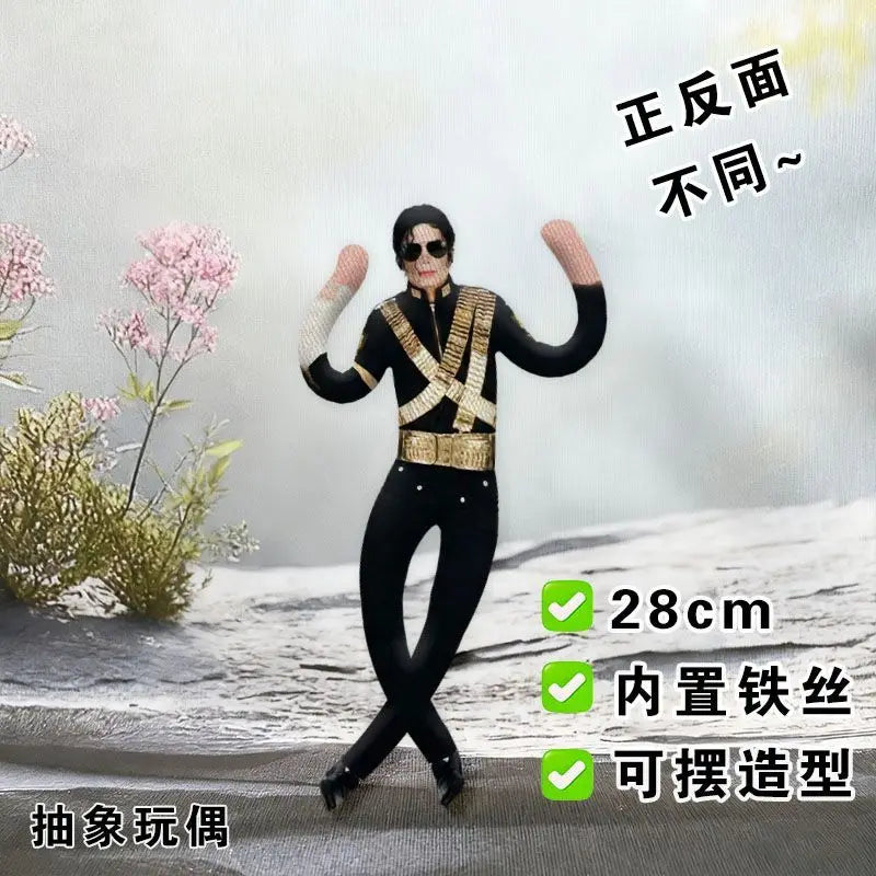 A black and gold collectible plush doll of Michael Jackson in a poseable figure, shown from the front.