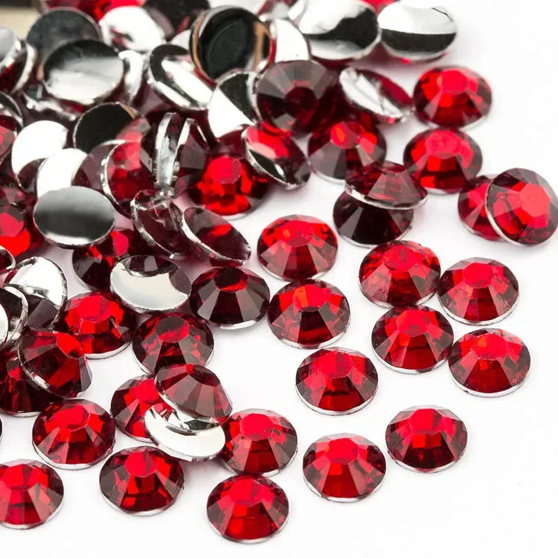 A close-up view of round flatback resin rhinestones in various shades of red and silver.