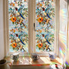 Botanical print window film featuring colorful birds and flowers on a glass pane