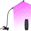 A purple USB LED plant grow light with a flexible arm and a remote control is shown illuminating a plant.