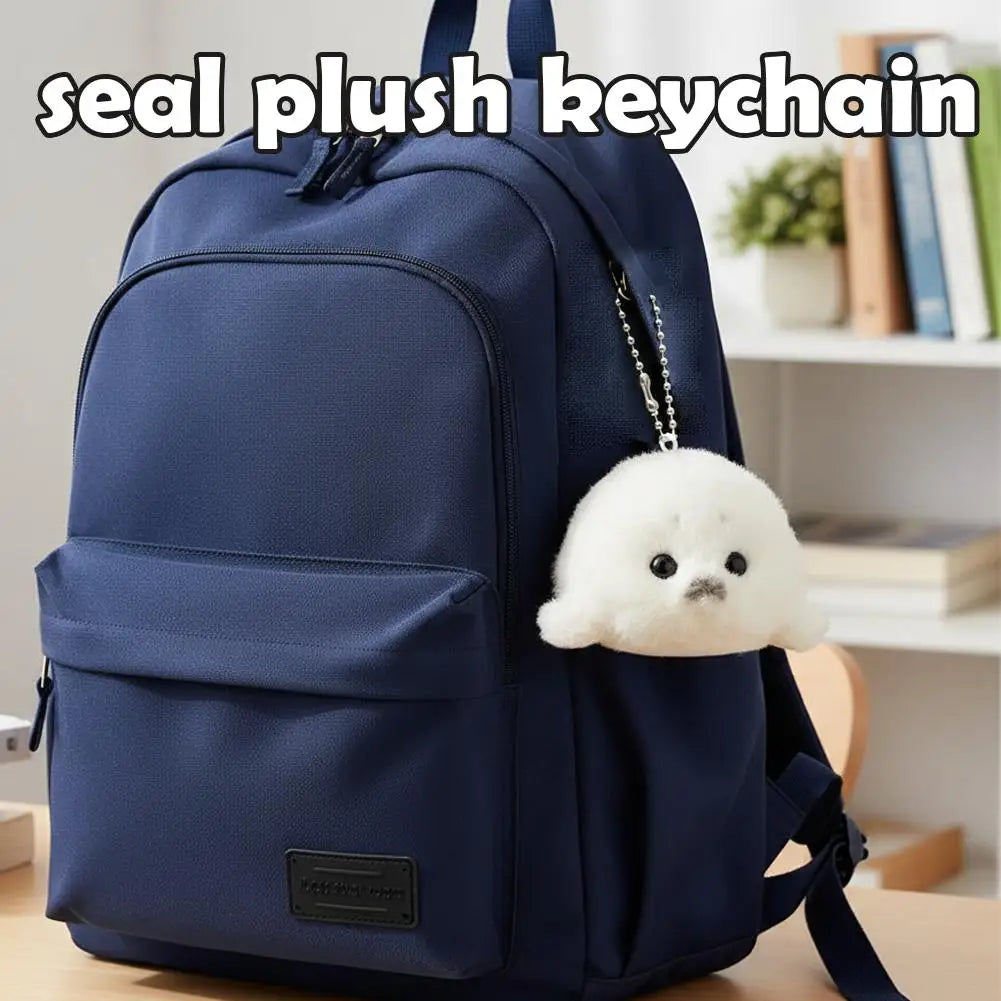A navy blue backpack with a seal plush keychain attached to the zipper pull.