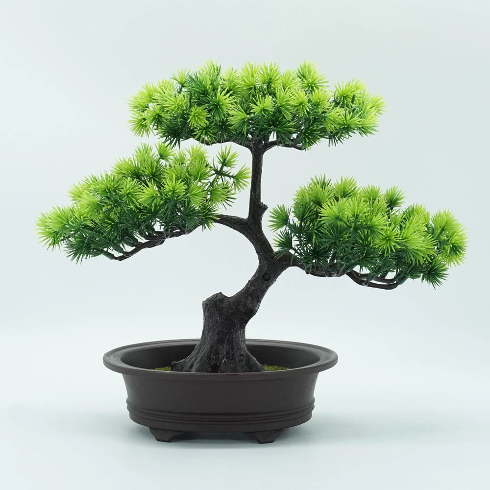 A small artificial bonsai tree with vibrant green needles growing from a dark trunk in a black pot.