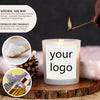 A lit soy candle in a glass jar with a custom label, surrounded by natural ingredients like pine cones and essential oils.