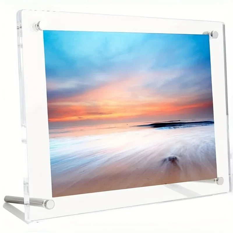 A clear acrylic photo frame displaying a vibrant sunset over the ocean with soft, blurred waves.