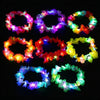 A collection of glowing LED flower crowns in various colors including pink, purple, blue, green, and orange.