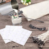 A candle making kit showing a metal melting pot, pouring pitcher, wax, and white wax pellets on a wooden surface.