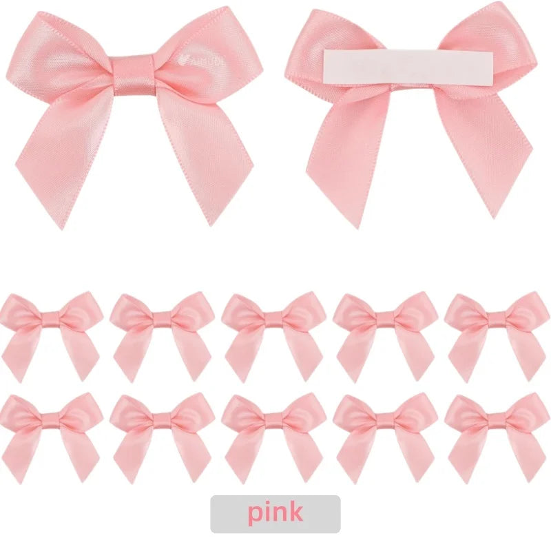 A set of pink satin ribbon bows with self-adhesive backing for crafting and gift wrapping.