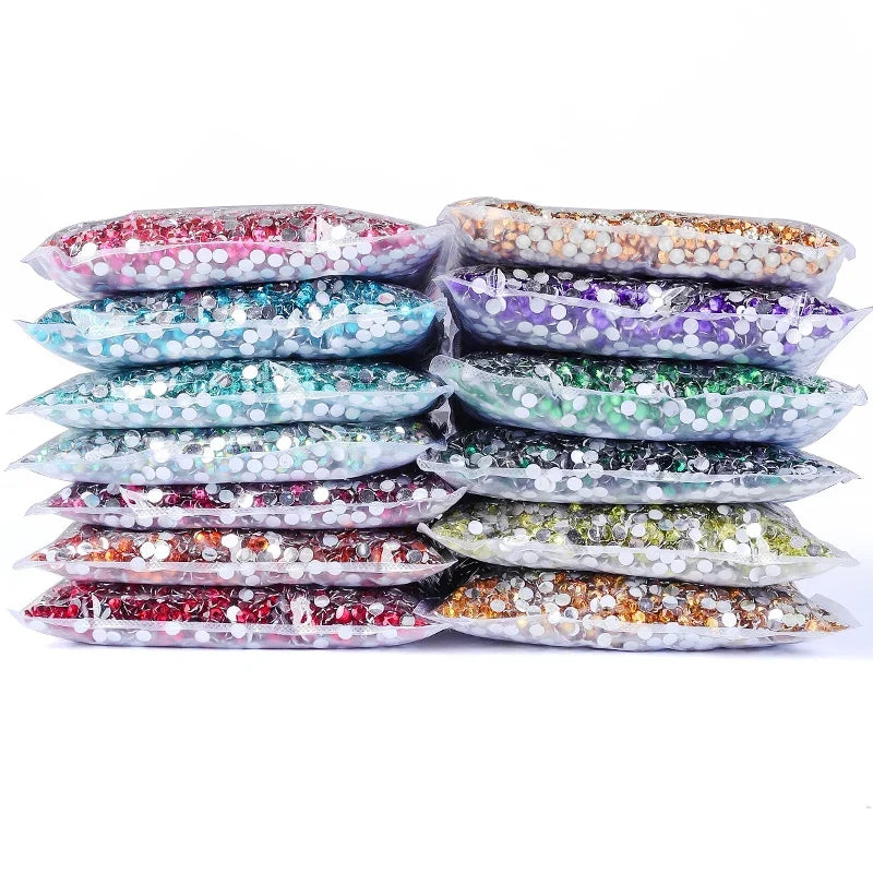 A collection of round flatback resin rhinestones in various colors and shades, displayed in a pile.