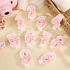 A set of six pink bowknot birthday candles in various numbers, including 1 through 6, arranged on a light background.