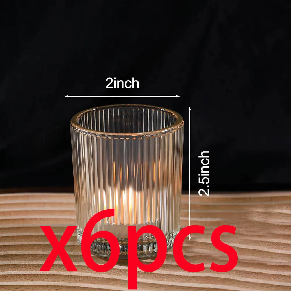 Six vintage striped glass votive candle holders sitting on a wooden surface.