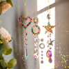 A collection of crystal rainbow sun catchers featuring heart, star, and circle designs hanging against a bright background.