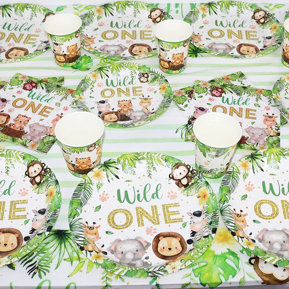 A set of green and white jungle safari themed tableware including plates and cups for a birthday party.