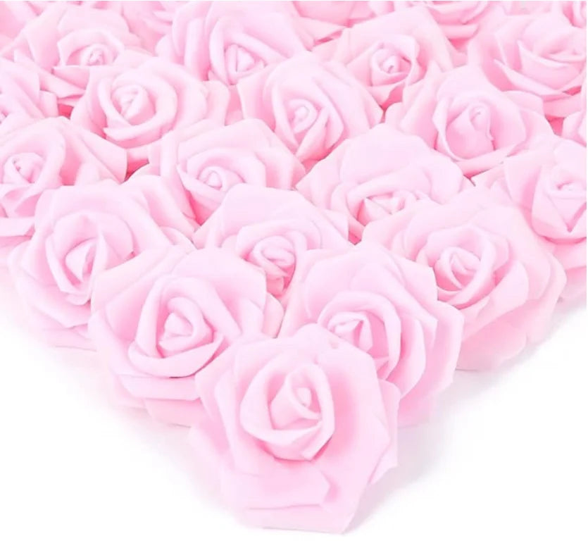 A dense arrangement of pink artificial foam rose decorations.
