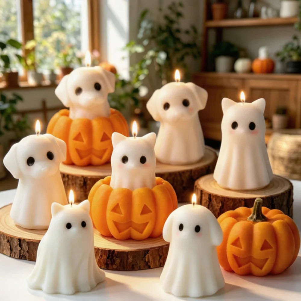 White silicone candle molds shaped like ghosts, cats, dogs, and pumpkins displayed on a wooden surface.