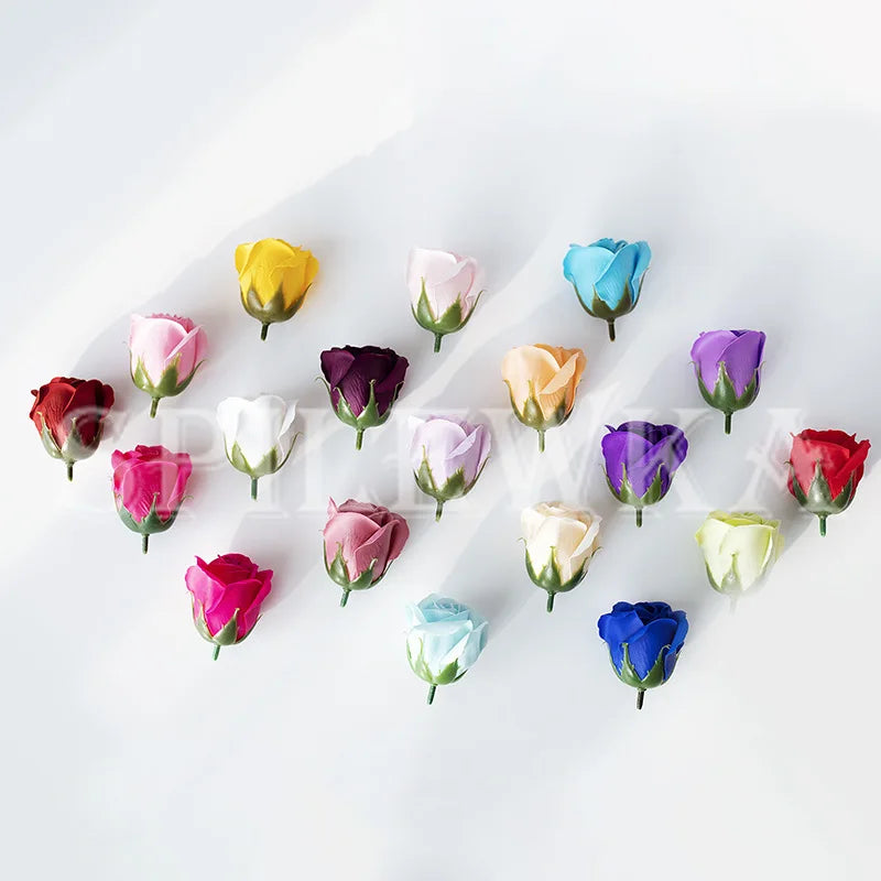 A collection of colorful artificial rose heads in various shades including yellow, pink, purple, and blue.