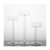 Three clear crystal glass candle holders with slender stems and round bases.