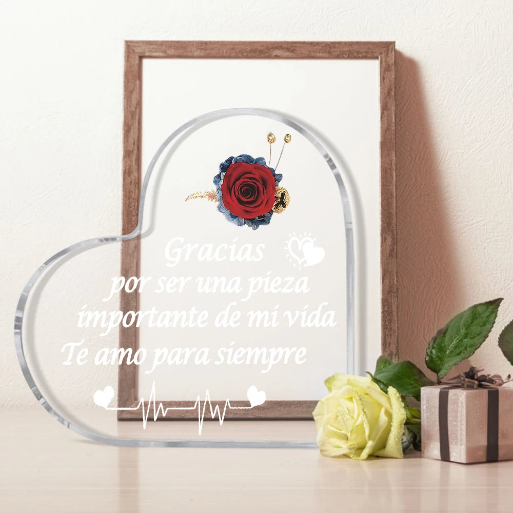 A framed piece of art featuring a red rose and text that reads Gracias por ser una pieza importante de mi vida Te amo para si