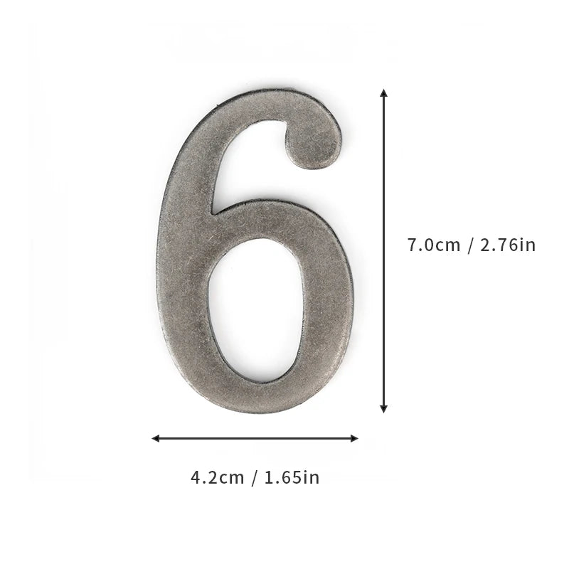 A silver magnetic house number shaped like the numeral six, measuring 7.0cm by 4.2cm.