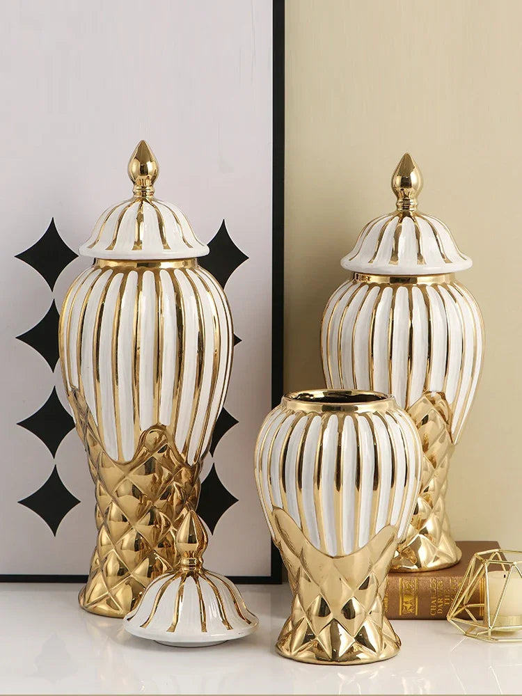 A pair of gold and white striped ceramic decorative vases with lid on a light background.