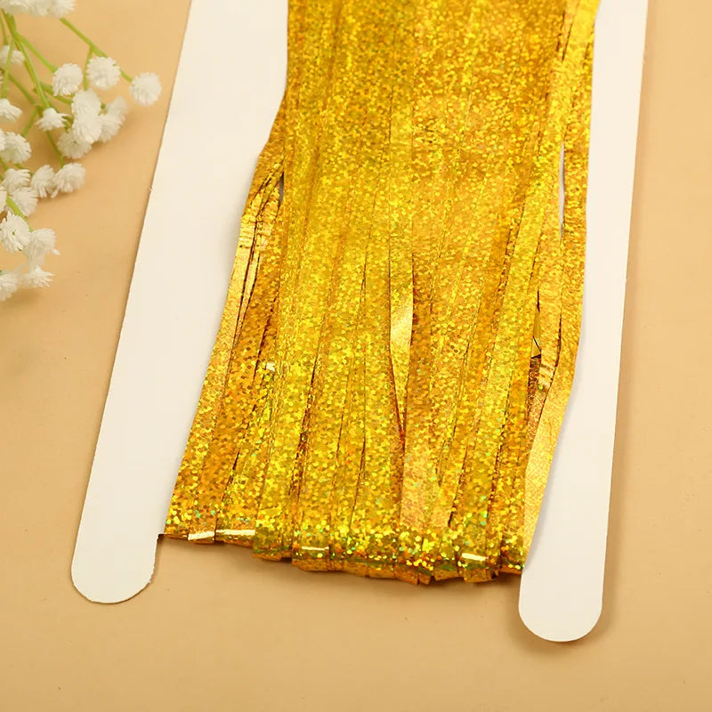 Golden metallic tinsel foil fringe curtain backdrop with gold glitter strands
