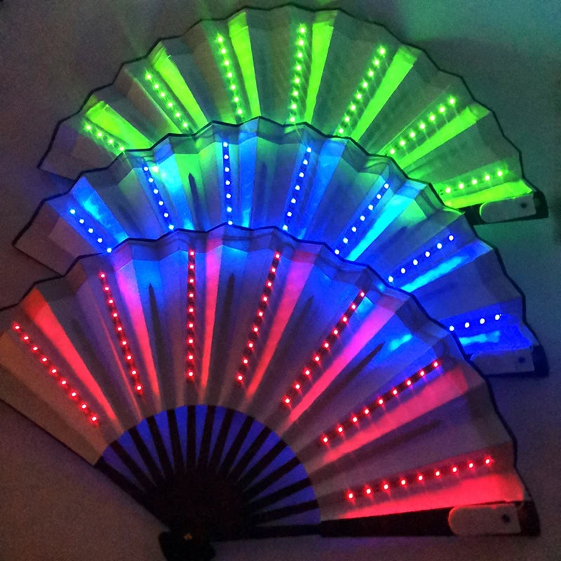 A fan of folding LED lights displaying a rainbow spectrum of green, blue, and red light.