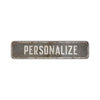 A rectangular, weathered gray aluminum street sign with the word PERSONALIZE engraved on it.