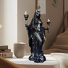A dark resin statue of a goddess with horns and mystical details, displayed on a white surface.