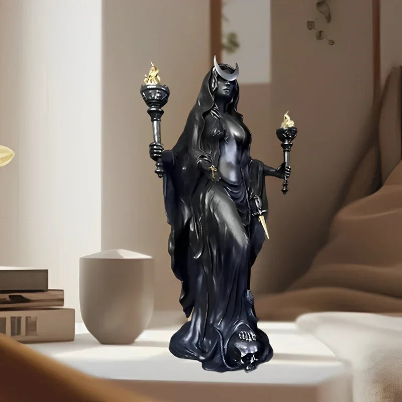 A dark resin statue of a goddess with horns and mystical details, displayed on a white surface.