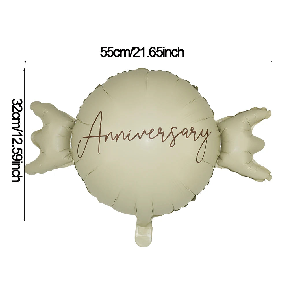 A light beige foil balloon shaped like a bear with the word Anniversary written on it.