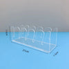 Clear acrylic storage rack with multiple display slots for caps, shown on a blue surface.