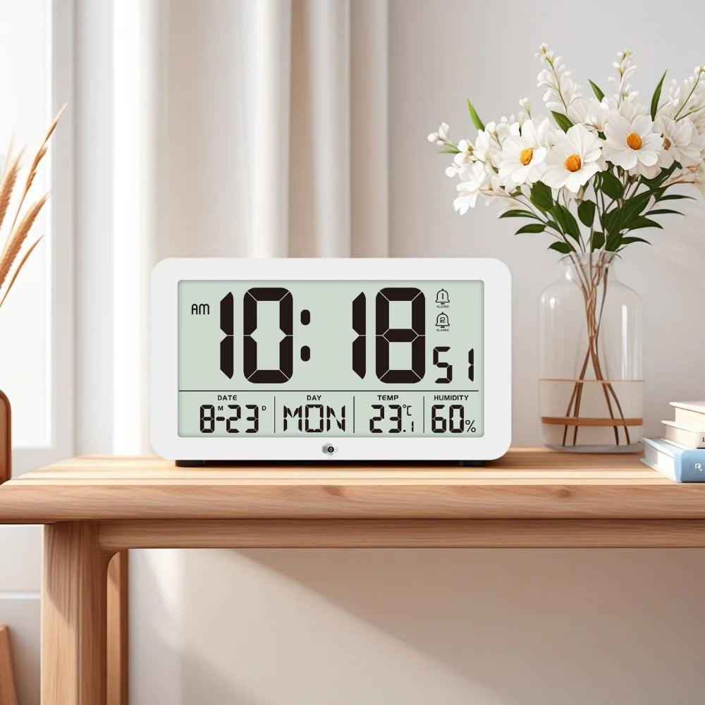 A white digital wall clock displaying 10:18 AM, with temperature and humidity readings visible on the screen.