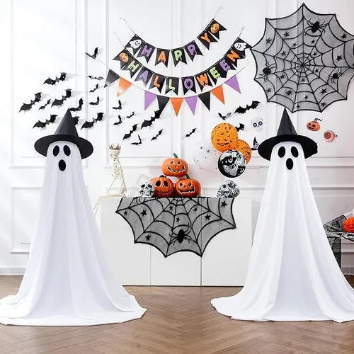 A white ghost decoration with a pointed hat is displayed against a white wall decorated with Halloween banners and spiderwebs