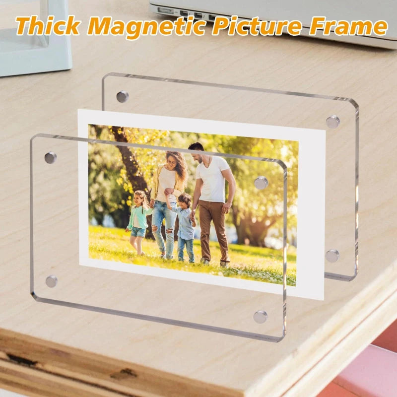 A clear acrylic picture frame magnet featuring a photo of a family outdoors on a wooden surface.