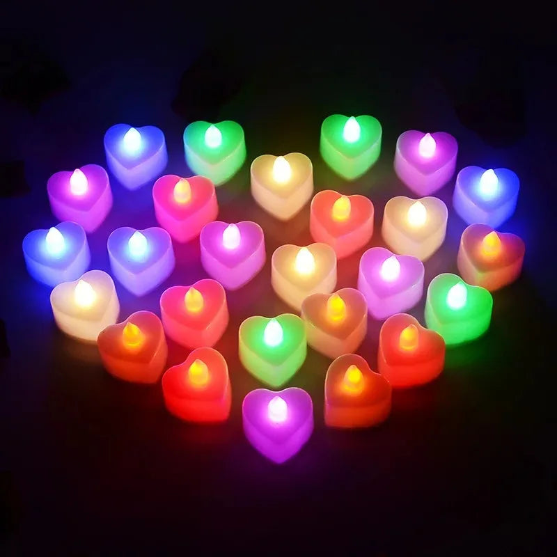 A collection of glowing LED heart-shaped tealight candles in various colors including purple, pink, green, and white.
