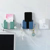 Wall-mounted organizer featuring a phone holder, charging dock, and various accessories mounted on a white tile surface.
