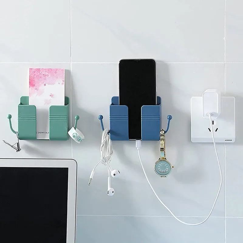 Wall-mounted organizer featuring a phone holder, charging dock, and various accessories mounted on a white tile surface.