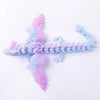 A 3D printed articulated dragon fidget figurine with translucent pink and blue scales.