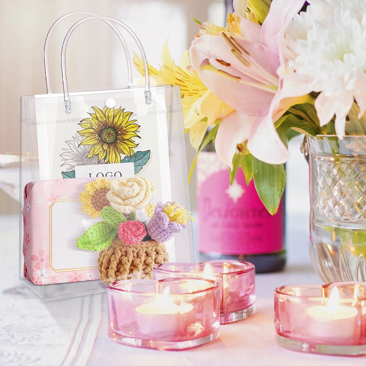 Clear reusable PVC gift bags with handles next to pink candles and floral arrangements