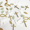 A collection of gold and white dove and cross shapes used for faith and celebration party decor