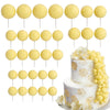 A set of yellow foam cake toppers arranged in rows for decoration.