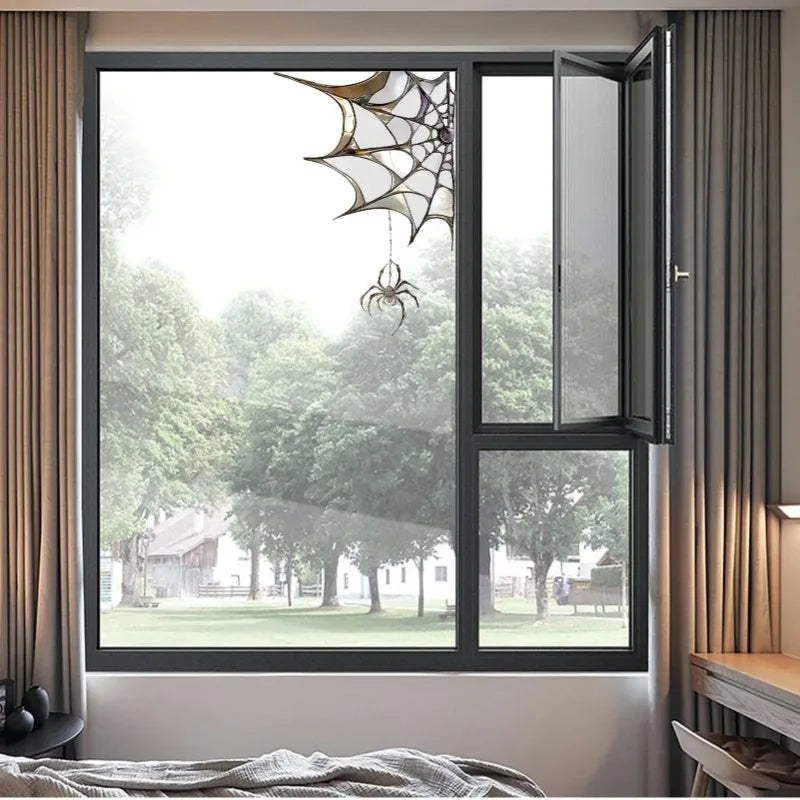 A window with a spider web decoration visible through the glass.