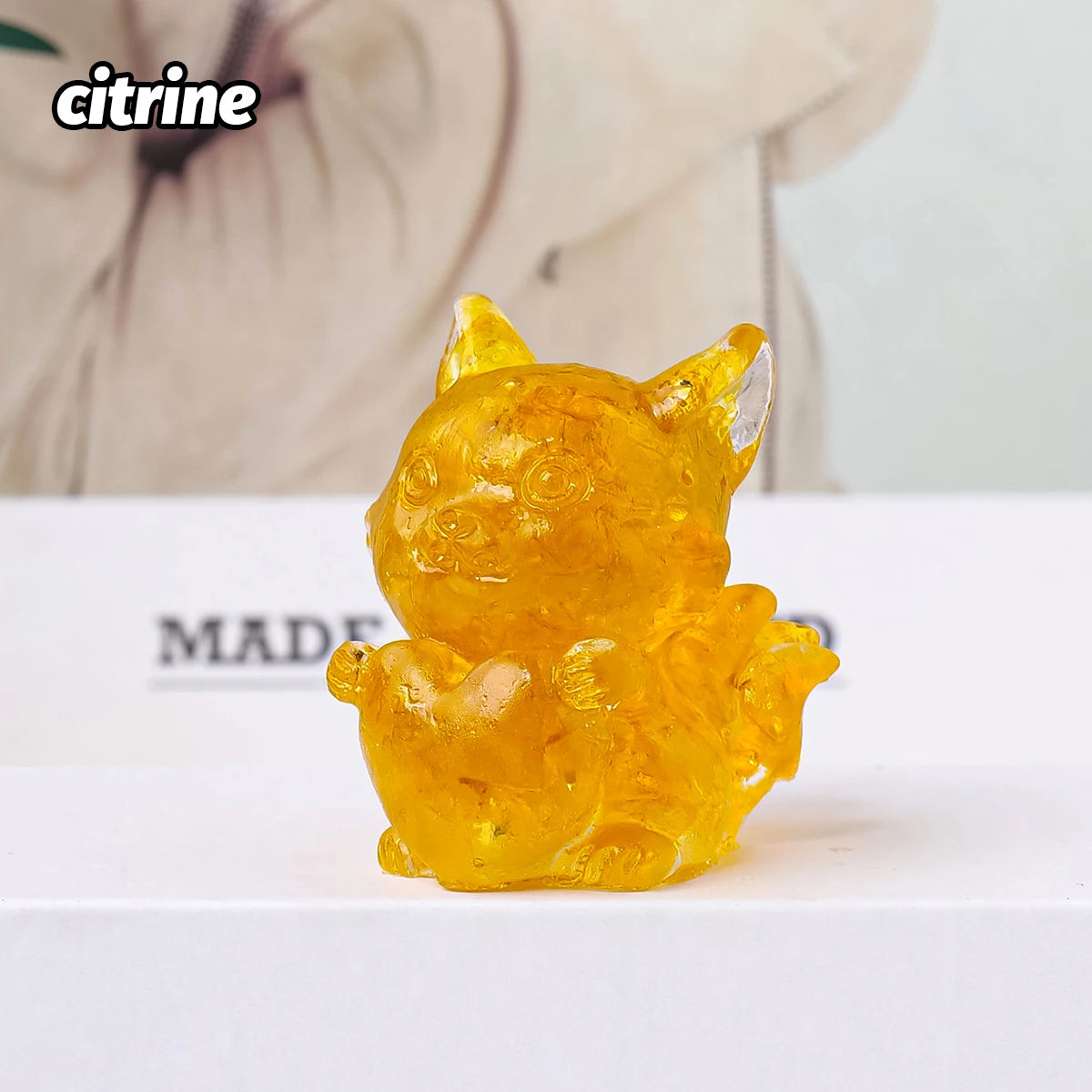 A small, translucent yellow natural fox crystal sculpture used for Feng Shui decor.