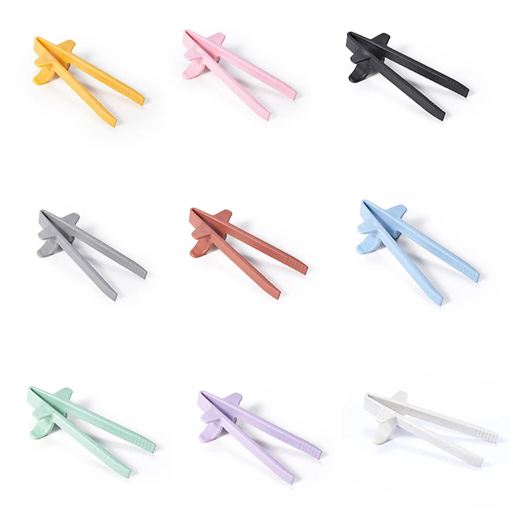 A collection of reusable wheat straw finger chopsticks in various colors including yellow, pink, black, gray, and light green