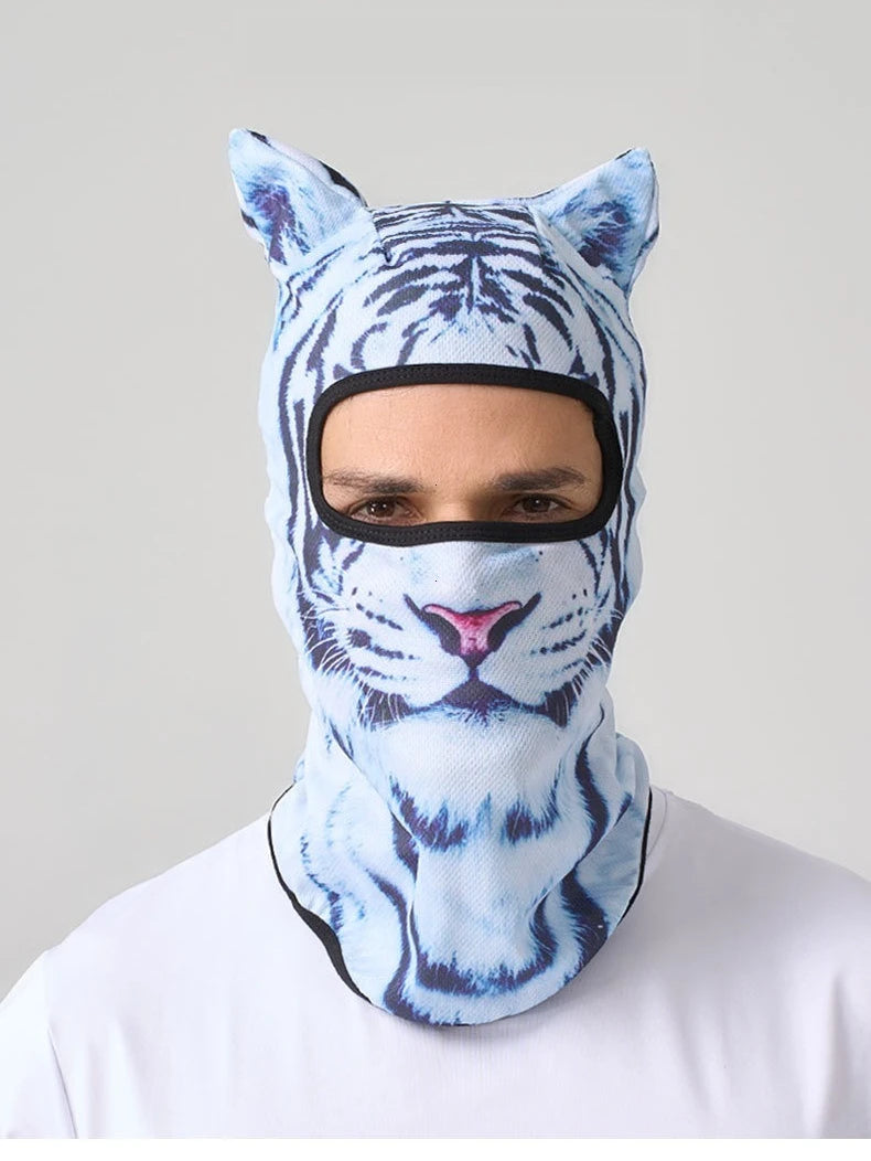 A person wearing a blue and white tiger print ski balaclava with cat ears.