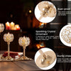 A set of gold-toned metal candle holders featuring a sparkling crystal ornament and sturdy finish.