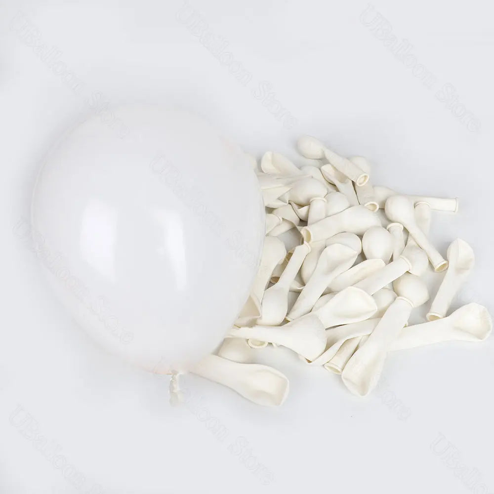 A bunch of white latex balloons in neutral shades for baby shower and birthday décor.